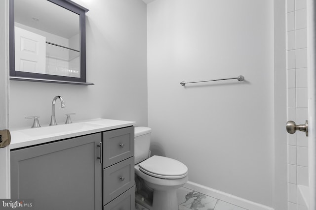 bathroom featuring vanity, toilet, and a shower