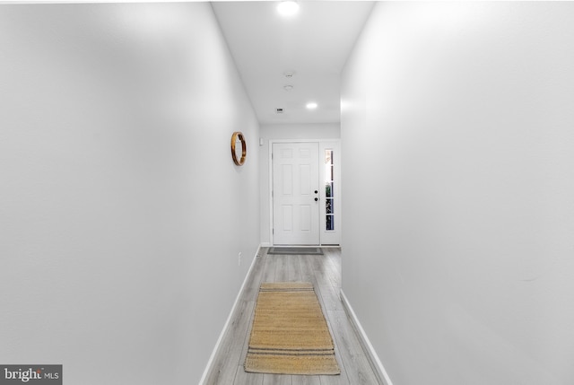 hallway with hardwood / wood-style flooring