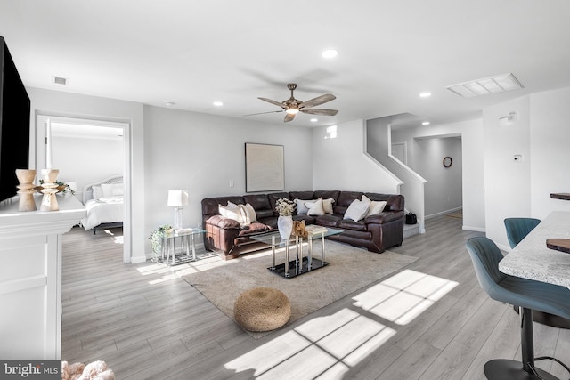 living room featuring ceiling fan and light hardwood / wood-style floors