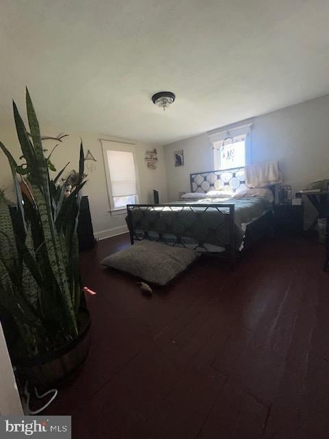 bedroom with dark hardwood / wood-style floors