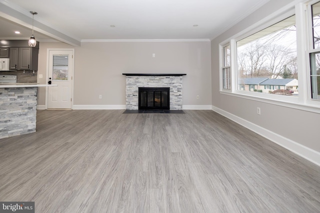 unfurnished living room with a fireplace, hardwood / wood-style flooring, and ornamental molding