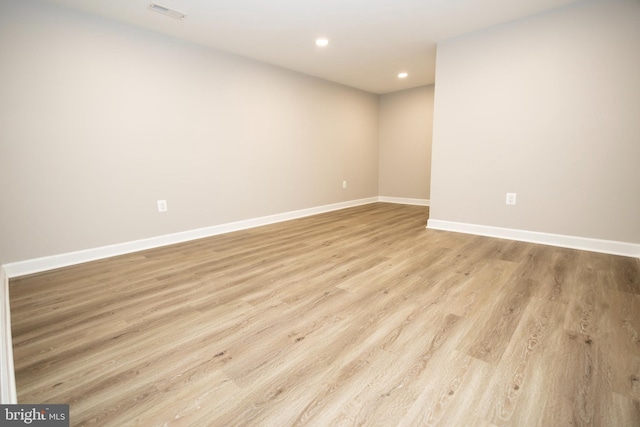 unfurnished room with light wood-type flooring