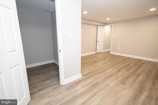 basement with light hardwood / wood-style flooring