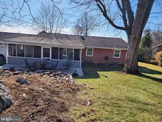 rear view of property featuring a yard