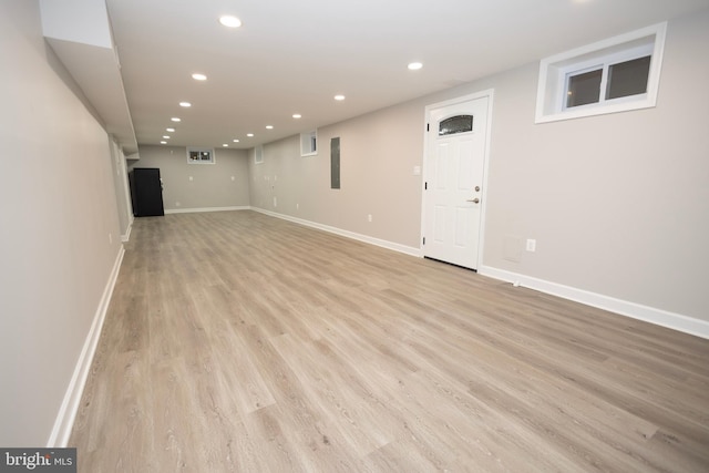 basement with light hardwood / wood-style flooring