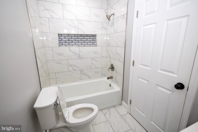 bathroom featuring tiled shower / bath combo and toilet