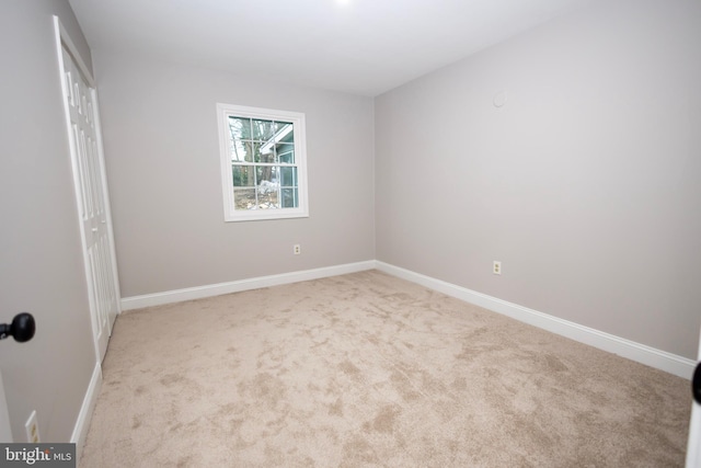 unfurnished bedroom featuring light carpet