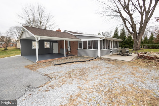 exterior space with a sunroom and a patio