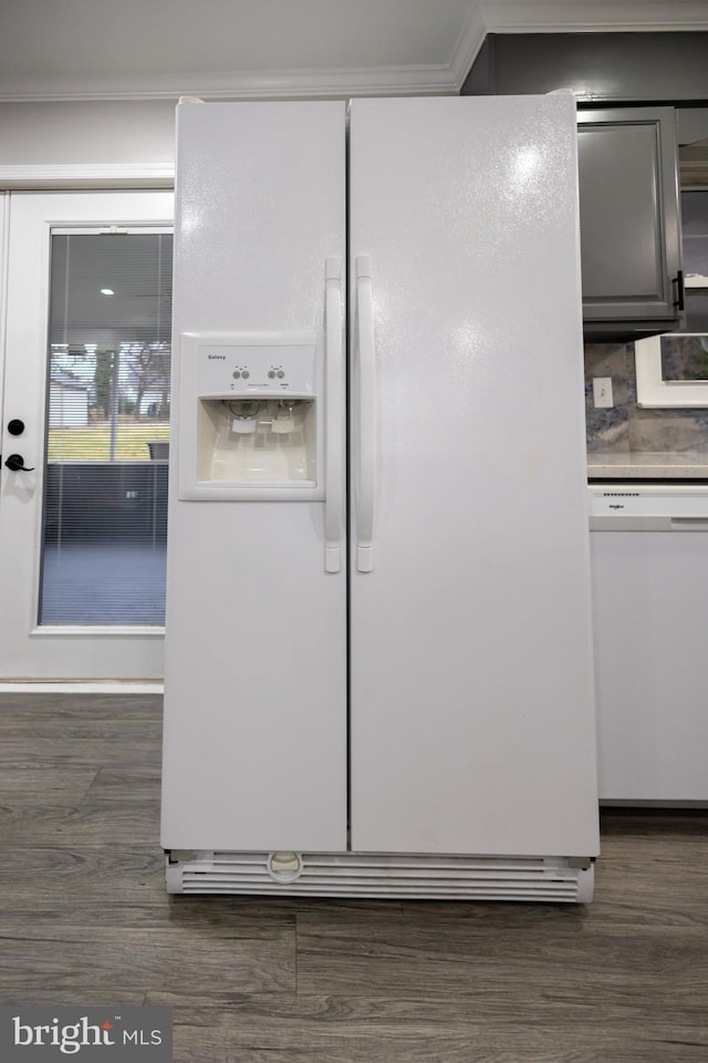 details with dark hardwood / wood-style flooring, white appliances, and ornamental molding