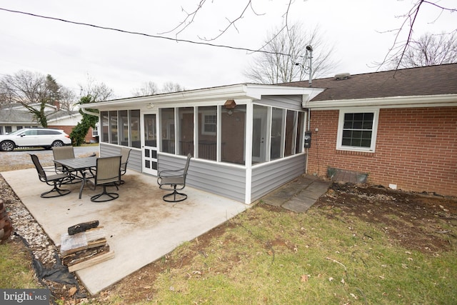 back of property featuring a sunroom and a patio