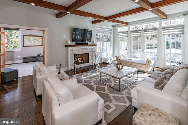 living area featuring dark wood-style floors, a premium fireplace, baseboards, and coffered ceiling