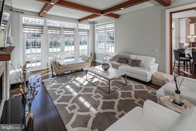 living room with coffered ceiling, a fireplace, beamed ceiling, and wood finished floors