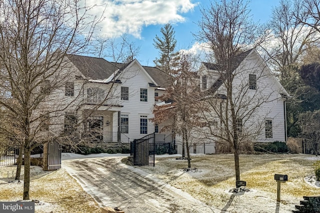 traditional-style house with a fenced front yard