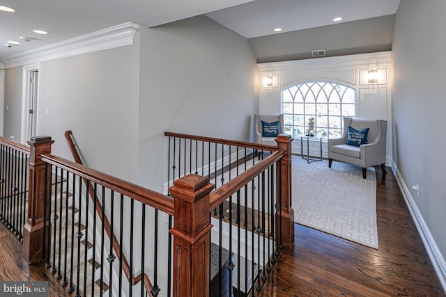 corridor with crown molding, baseboards, wood finished floors, and an upstairs landing