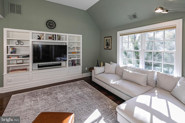 living area featuring visible vents, vaulted ceiling, and dark wood finished floors