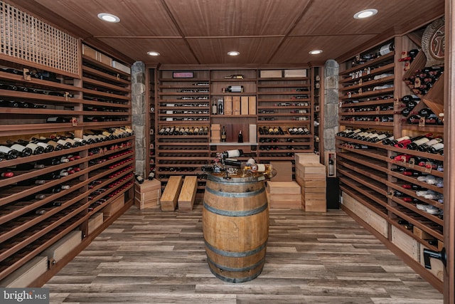 wine cellar with recessed lighting, wood ceiling, and wood finished floors