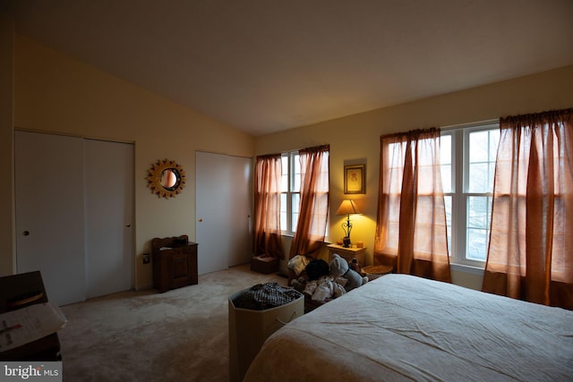 carpeted bedroom featuring vaulted ceiling