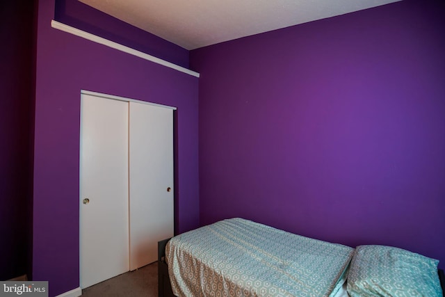 carpeted bedroom with a closet