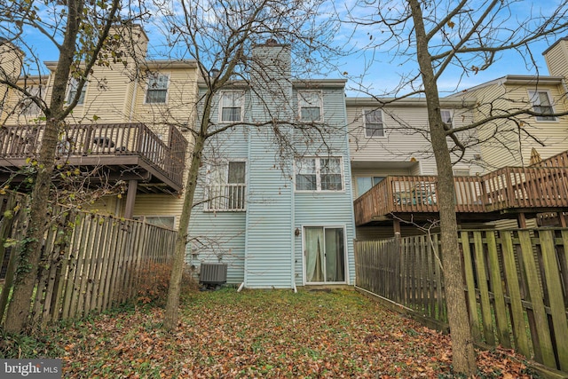 back of property with cooling unit and a wooden deck