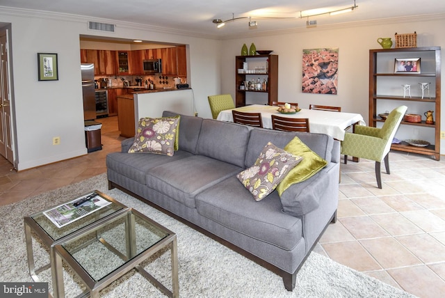 living room with crown molding and light tile patterned floors