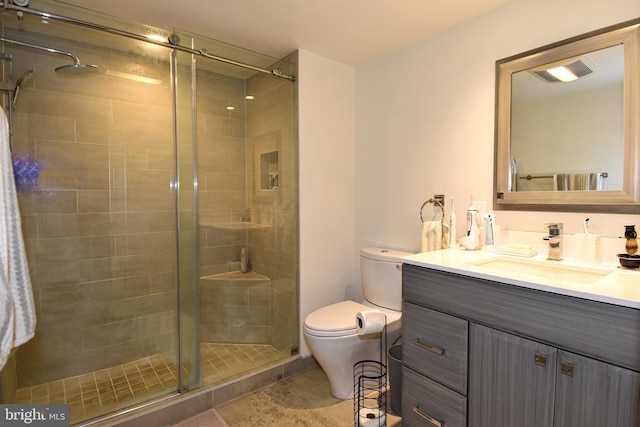 bathroom with vanity, toilet, and walk in shower