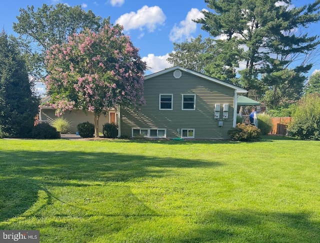 view of home's exterior with a lawn