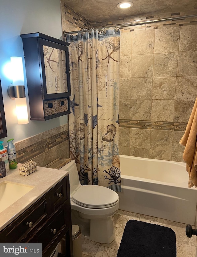 full bathroom featuring shower / bath combo, vanity, toilet, and tile walls