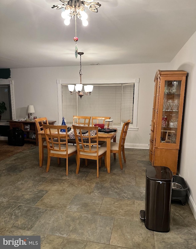 dining area with a notable chandelier