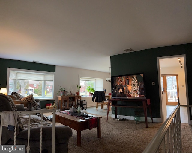 living room featuring plenty of natural light and carpet floors