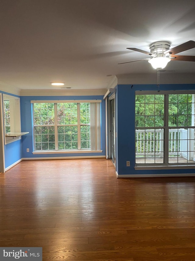 unfurnished living room featuring crown molding, ceiling fan, and wood-type flooring