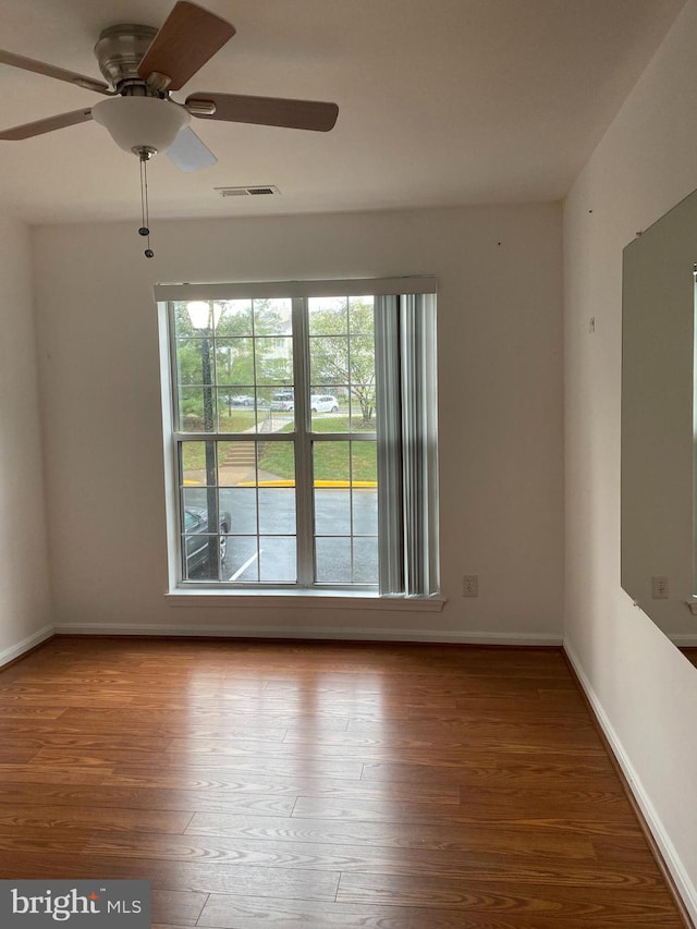 empty room featuring hardwood / wood-style flooring and ceiling fan