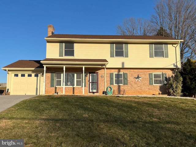 view of front of property featuring a garage and a front lawn