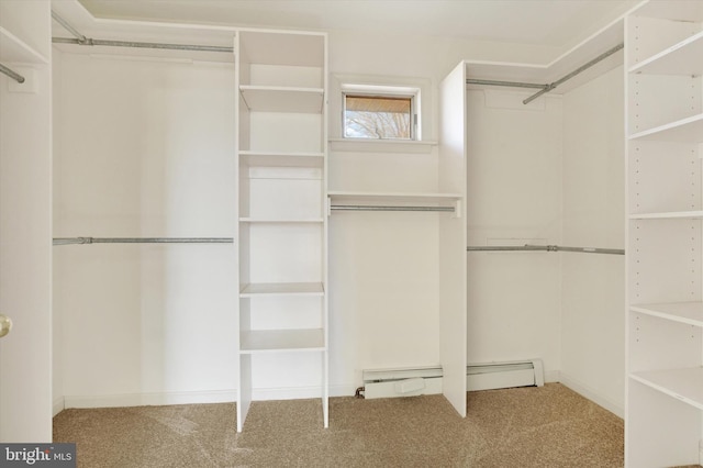 spacious closet with carpet and a baseboard heating unit