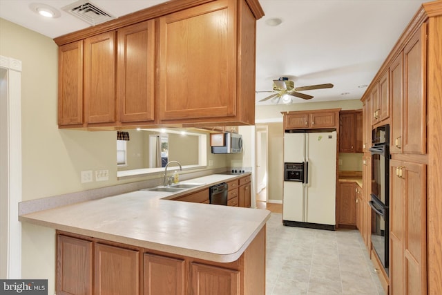 kitchen featuring sink, ceiling fan, light tile patterned floors, kitchen peninsula, and stainless steel appliances