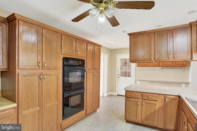 kitchen featuring double oven and ceiling fan