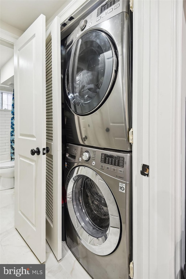 washroom featuring stacked washer and dryer