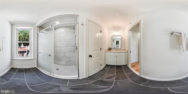 bathroom with vanity, a shower with shower door, and wood-type flooring