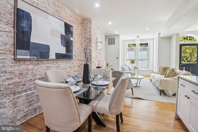 dining space with plenty of natural light and light hardwood / wood-style floors