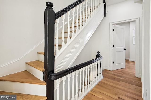 stairway with hardwood / wood-style flooring