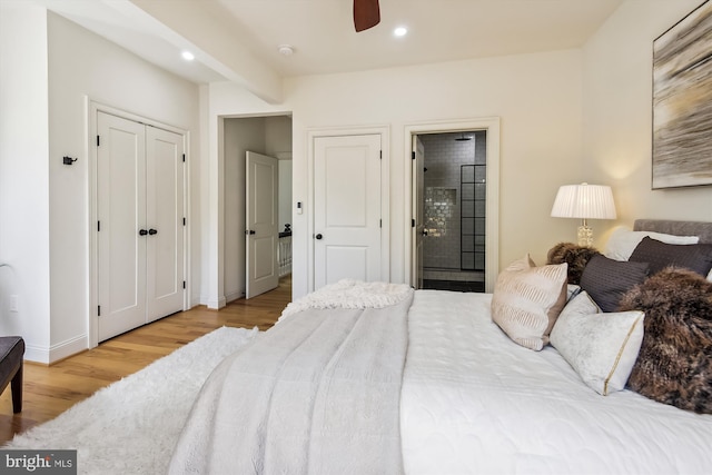 bedroom featuring hardwood / wood-style flooring, ceiling fan, and ensuite bath