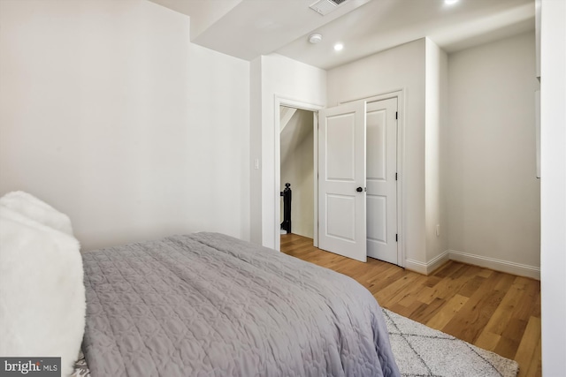 bedroom with light wood-type flooring and a closet