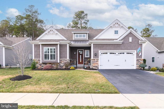 craftsman house featuring a garage and a front lawn