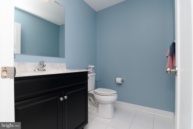 bathroom featuring tile patterned flooring, vanity, and toilet