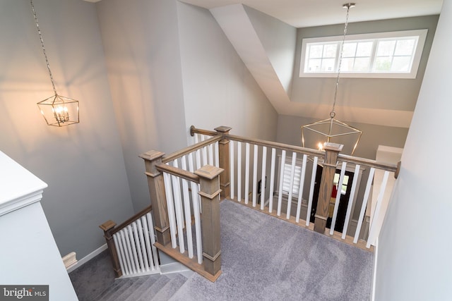 stairs featuring carpet flooring and a chandelier