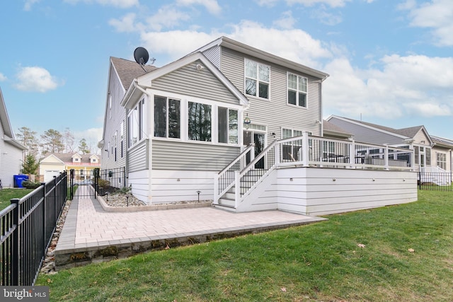 back of property with a lawn and a patio