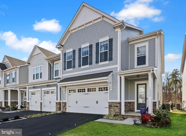 view of property with a garage and central air condition unit