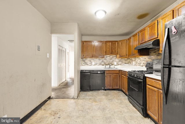 kitchen featuring black appliances, sink, and tasteful backsplash