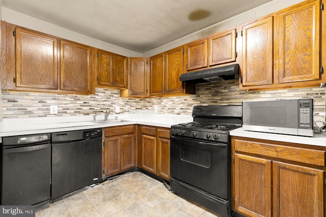 kitchen with decorative backsplash, sink, light tile patterned flooring, and black appliances