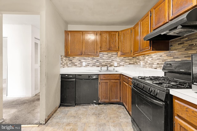 kitchen featuring black appliances, decorative backsplash, ventilation hood, and sink