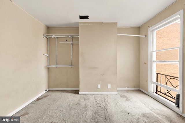 unfurnished bedroom featuring light colored carpet and a closet